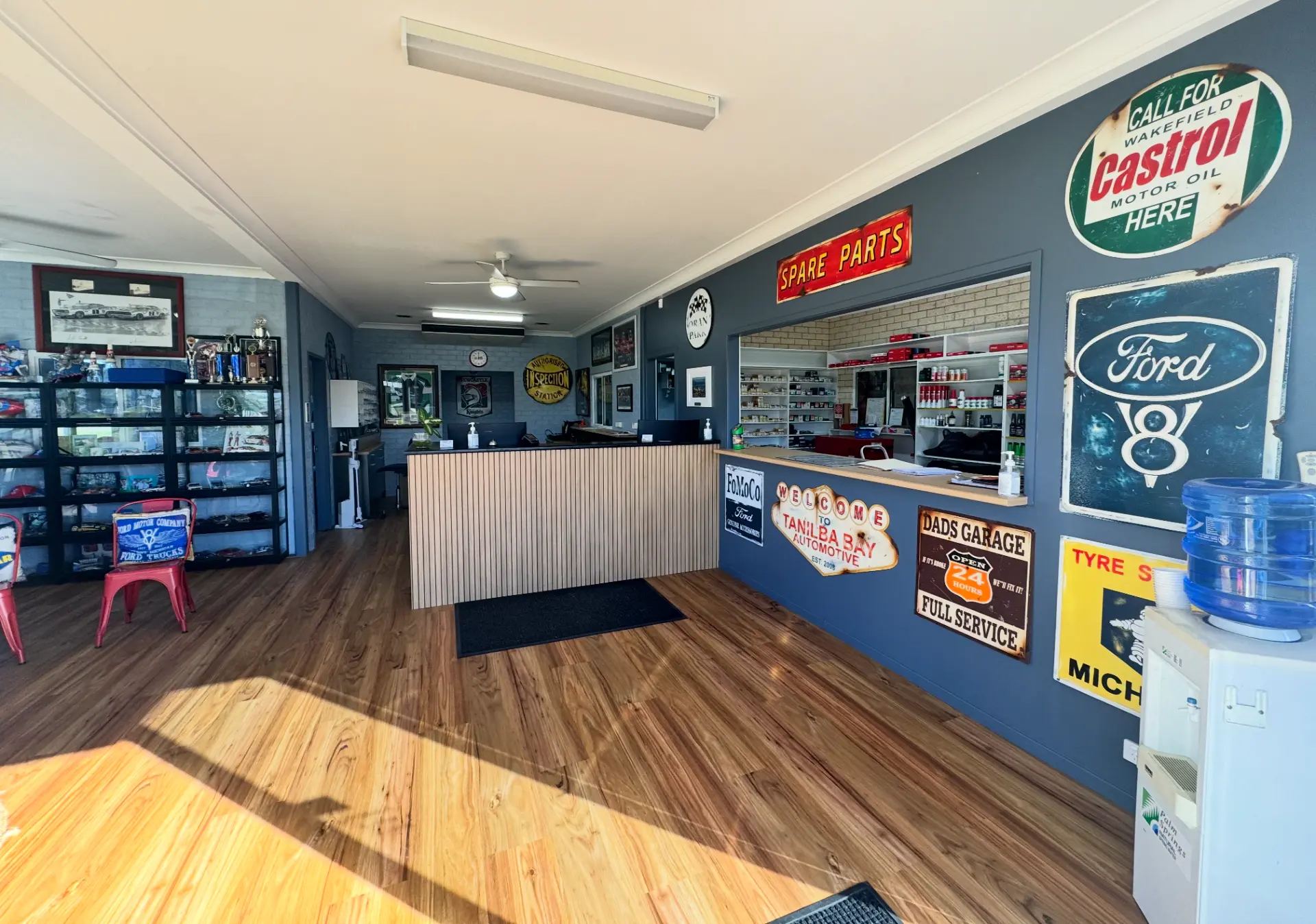 The Tanilba Bay Automotive reception and spare parts counter with vintage motoring signage