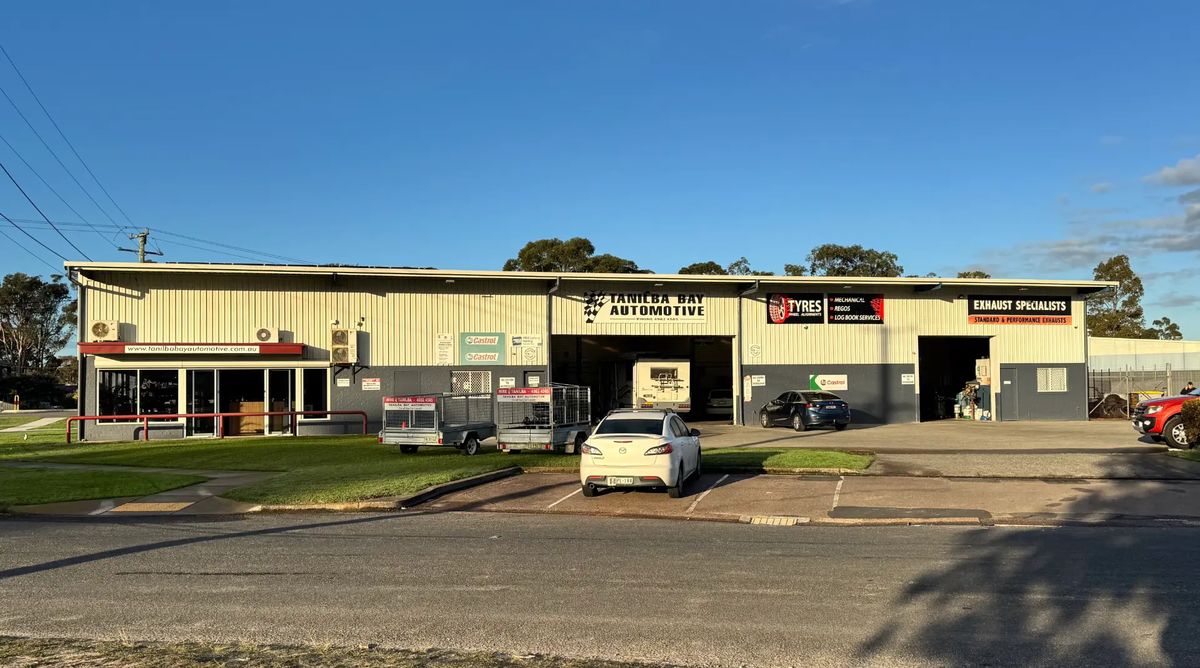 Tanilba Bay Automotive workshop exterior with service bays, trailers for hire and customer parking